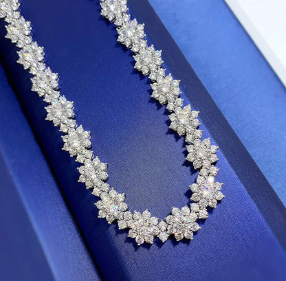 A 925 sterling silver necklace with a sunflower design, displayed against a blue background.