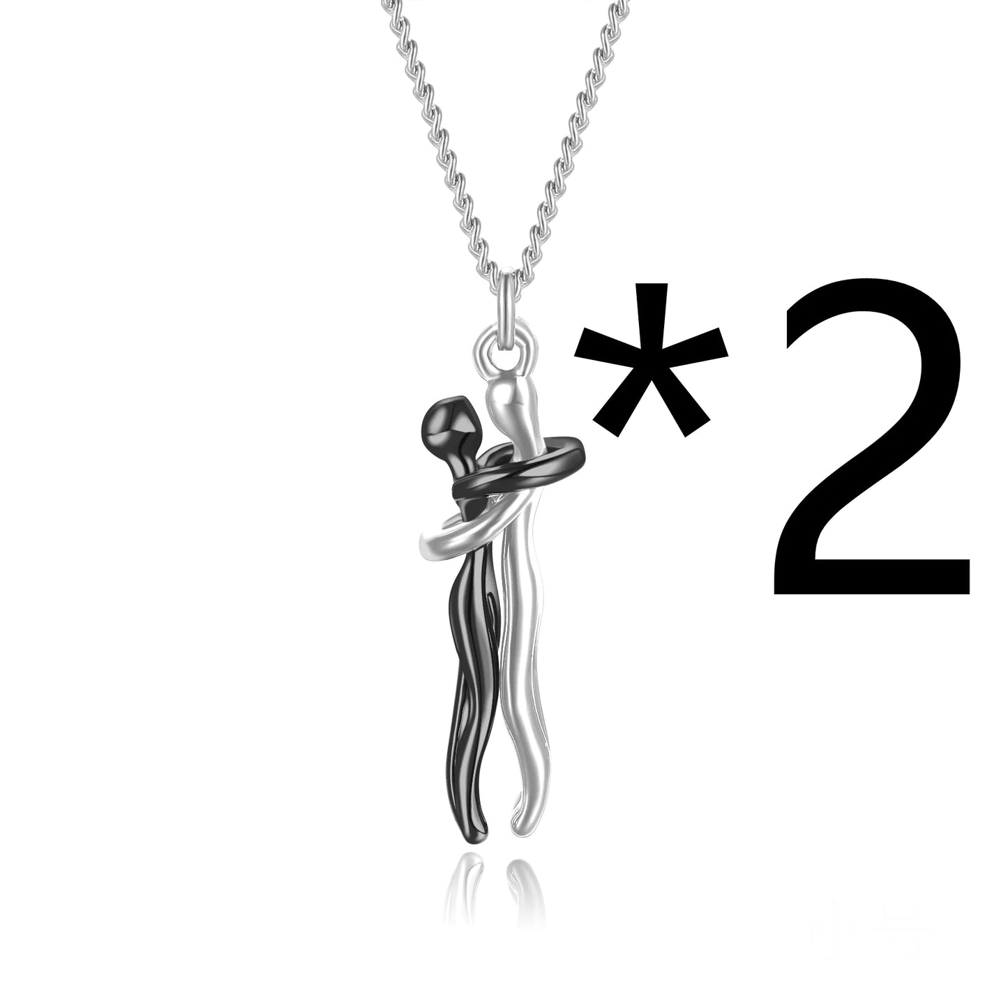 A pendant necklace featuring two figures in a hugging embrace, with the necklace chain visible at the top of the image. The main object is marked with an asterisk.