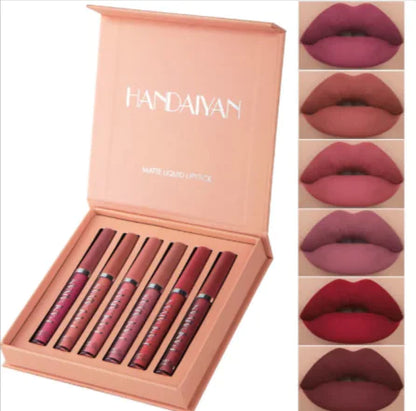 A set of nine matte lip glosses in various shades of red and pink, displayed in a box with the brand name Handaiyan on the top. Each lip gloss is shown applied to lips, indicating the color and finish.