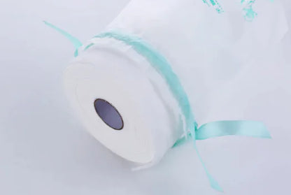 White plush toy with blue ribbon on a light background