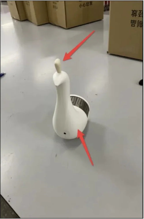 A white peacock-shaped 3D wall lamp with red arrows indicating the light source