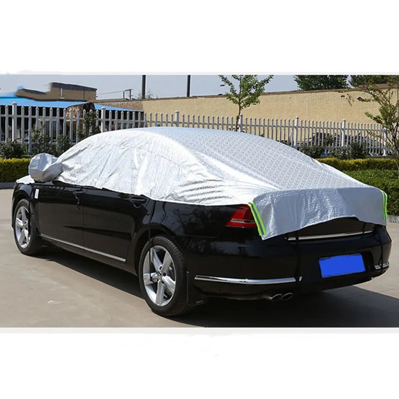 A car covered with a silver-colored aluminum film sunshade.