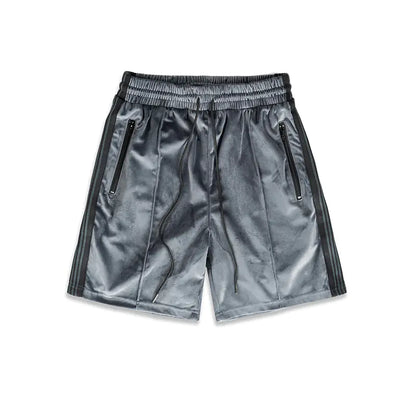 A pair of gray suede sports webbing shorts with a mid-waist design, side pockets, and a drawstring waistband.