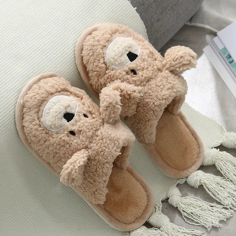 A pair of beige plush slippers designed to resemble a bear, with a round toe shape and a non-slip sole.