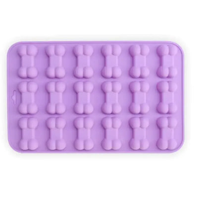 A silicone cake mold featuring shapes for dino bones, with two colors shown: purple and pink.