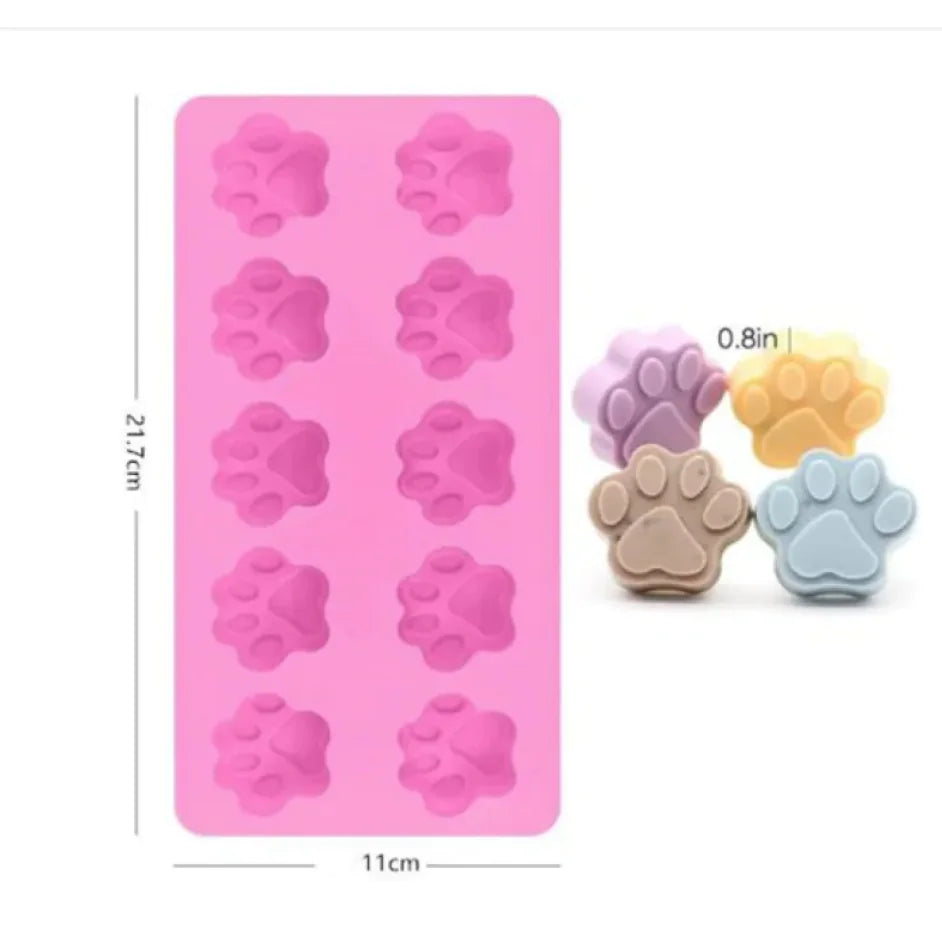 A silicone cake mold featuring shapes for dino bones, with two colors shown: purple and pink.