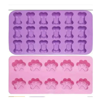 A silicone cake mold featuring shapes for dino bones, with two colors shown: purple and pink.