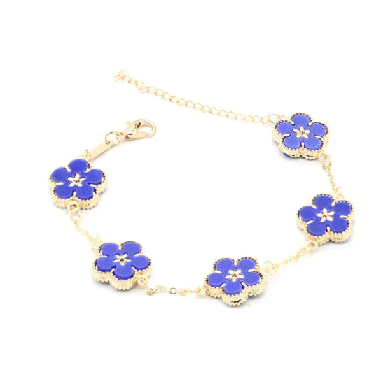 A gold-colored bracelet with a plum blossom design, featuring multiple flowers connected by a chain.