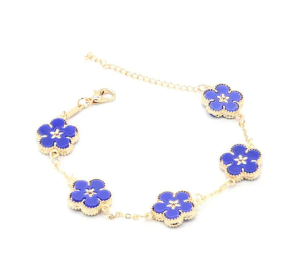 A gold-colored bracelet with a plum blossom design, featuring multiple flowers connected by a chain.