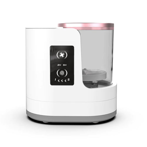 A white electric makeup brush cleaner and dryer with a transparent container and pink accents. It has a USB symbol and directional buttons displayed on the front.