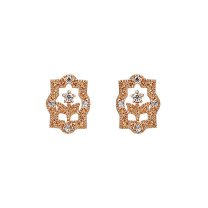 A pair of rose gold-colored earrings with a floral design and zircon embellishments.