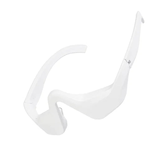 A white, sleek eye bag remover device with a curved design for the under-eye area.