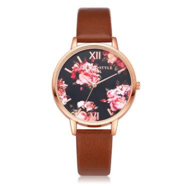 A rose gold watch with a floral dial and a pink PU strap.