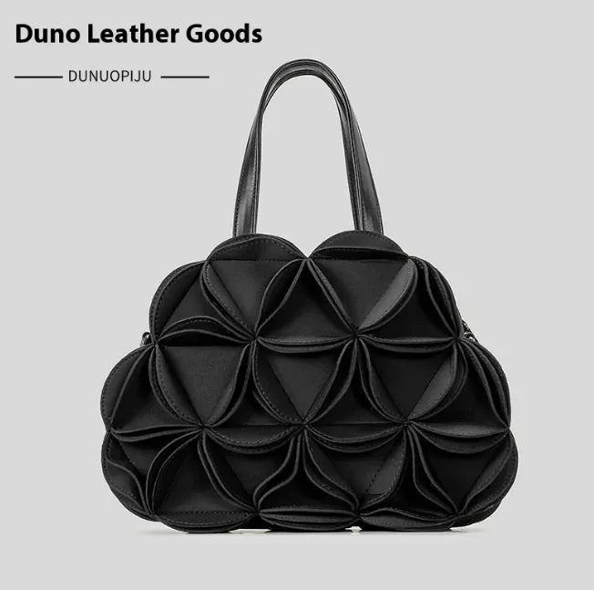 A black flower-shaped shoulder bag with PU stitching details, displayed against a white background.