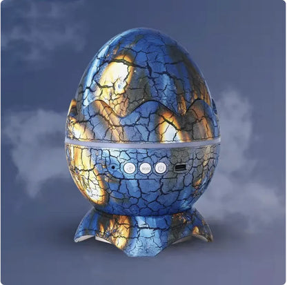 A Galaxy Starlight LED Projector with a dinosaur egg shape, displaying a blue and gold pattern, set against a simulated night sky background.