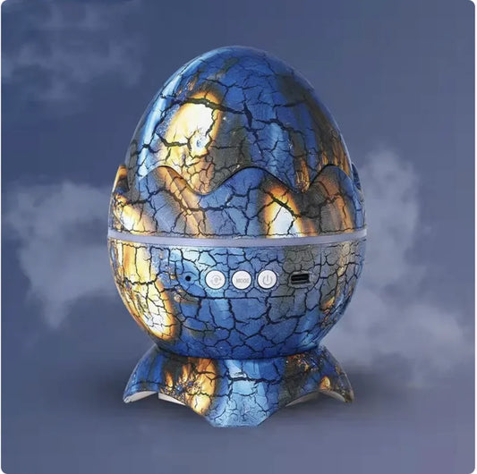 A Galaxy Starlight LED Projector with a dinosaur egg shape, displaying a blue and gold pattern, set against a simulated night sky background.