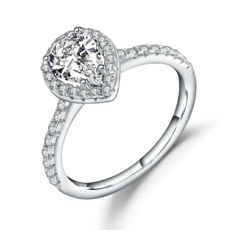 A sterling silver ring with a central diamond inlay surrounded by smaller gemstone inlays on the band.