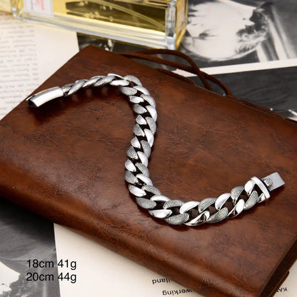 A silver fashion bracelet with a glossy snake pattern, displayed on a brown leather surface.