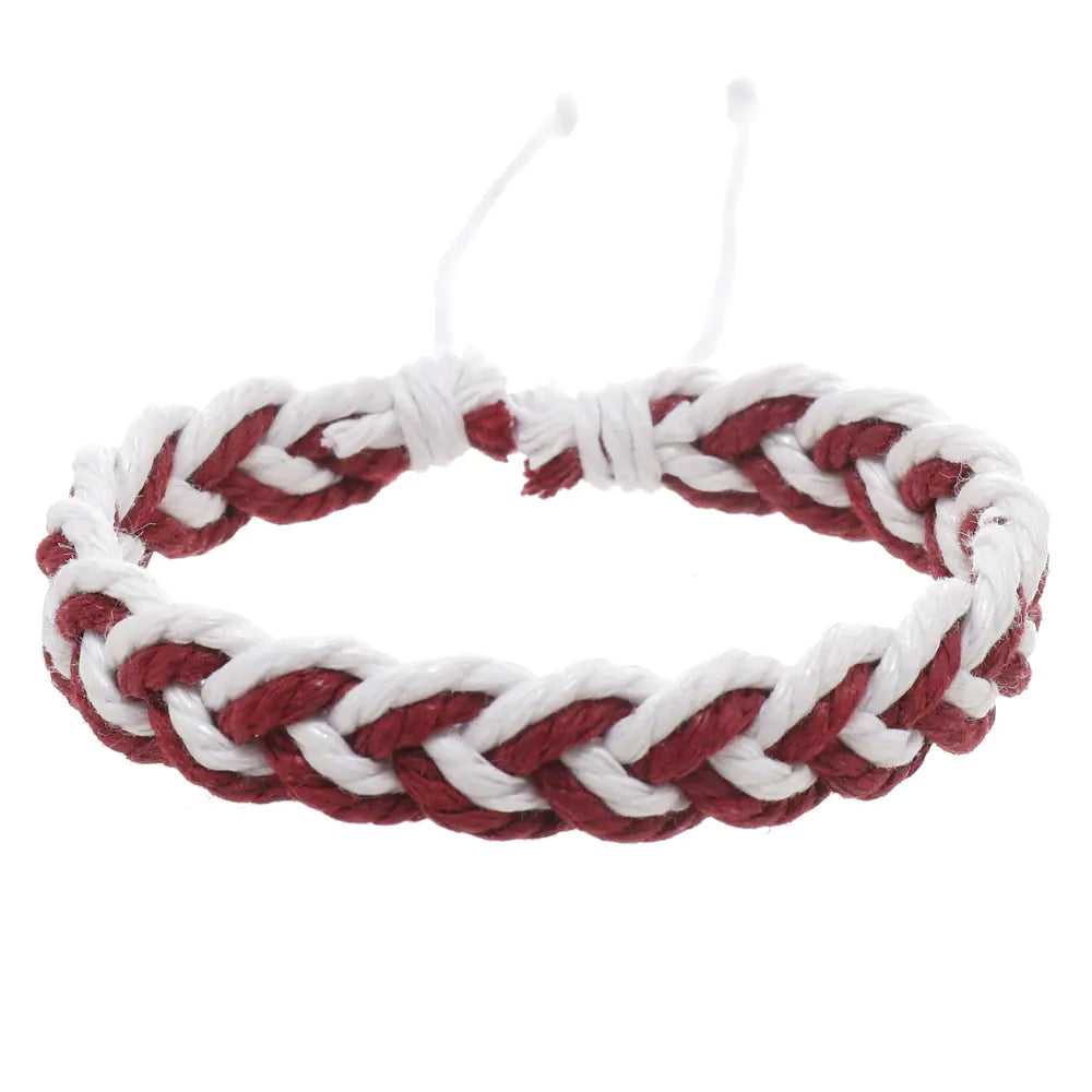 A handwoven cotton string bracelet in red and white, featuring an artistic style with a wave pattern.