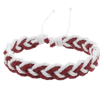 A handwoven cotton string bracelet in red and white, featuring an artistic style with a wave pattern.