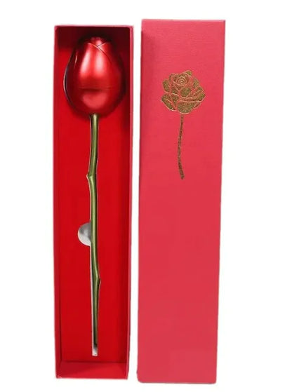 The image shows a heart-shaped zircon crystal necklace displayed on a white background, alongside its red box packaging which has a rose design. The necklace features a silver chain and a heart-shaped pendant with a red zircon crystal.