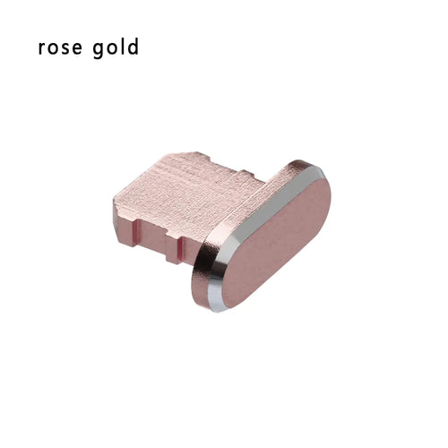 A rose gold dust plug for an iPhone's charging port made of aluminum alloy.