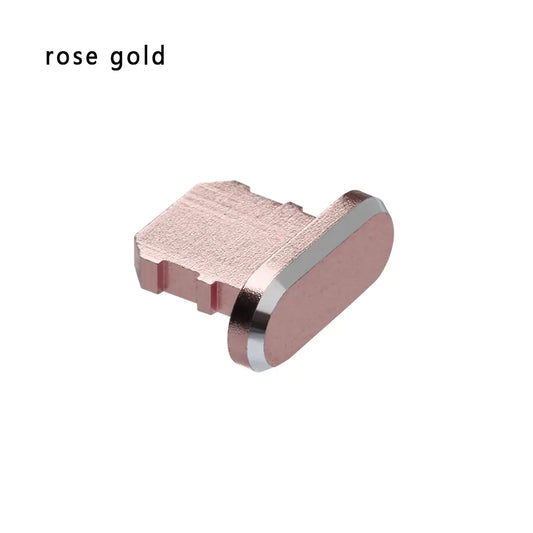 A rose gold dust plug for an iPhone's charging port made of aluminum alloy.