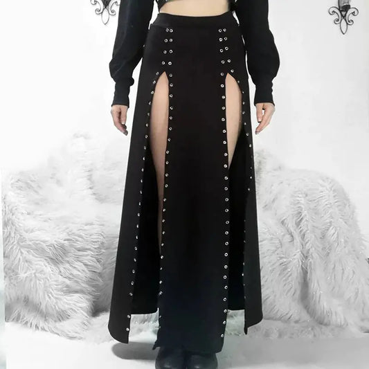 A high-waist mid-length black skirt with rivet and slit design, paired with a black top and displayed in front of a white furry background.