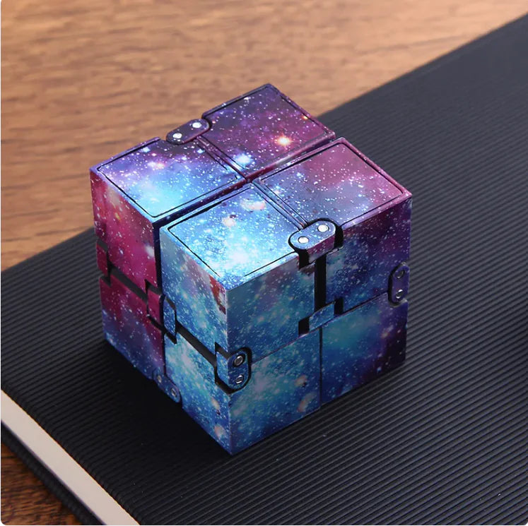 A black infinity cube antistress toy made of plastic, featuring a fidget design with multiple moving parts.