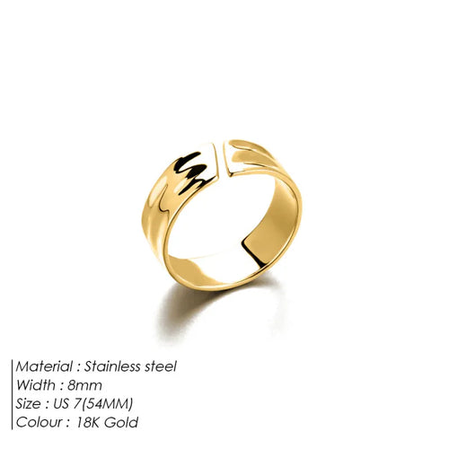 A gold-colored ring with an irregular concave-convex pattern and smooth opening, displayed against a white background.