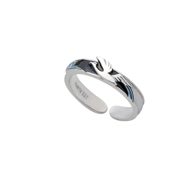 Two rings with a geometric design, one with blue accents and another with black accents, on a white background.