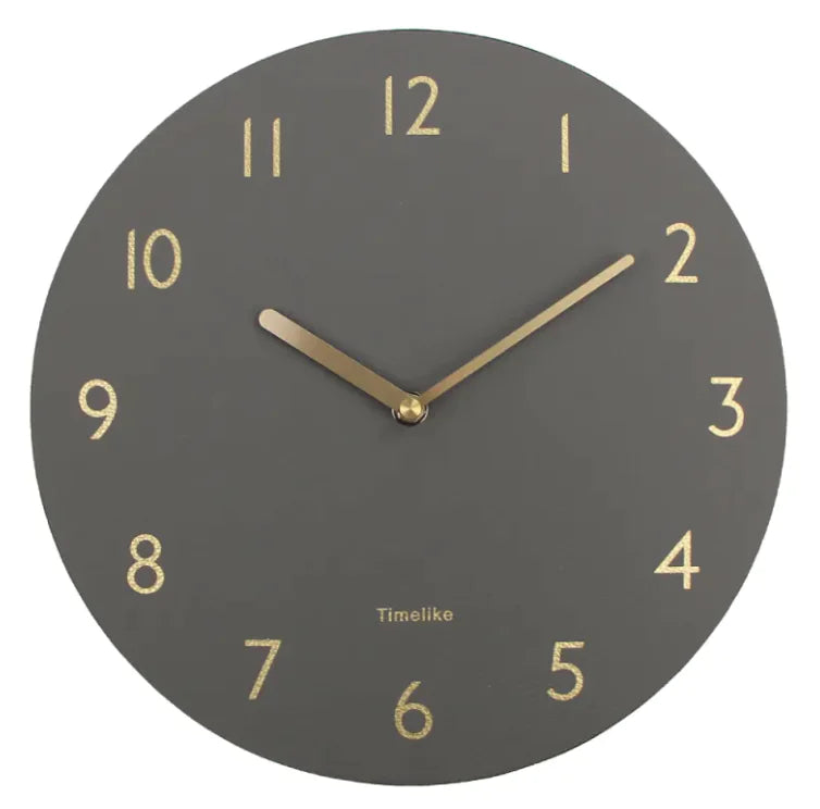 An oversized wall clock with a brown leather shell and a clear mirror dial, featuring black numbers and gold hands.