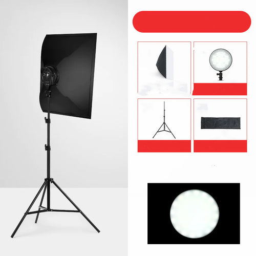 A collection of photography lighting equipment including a softbox on a stand, a reflector, and various light bulbs.