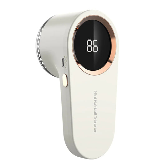 A portable electric lint remover with a digital battery indicator on the front, primarily white in color with a grey charging interface.