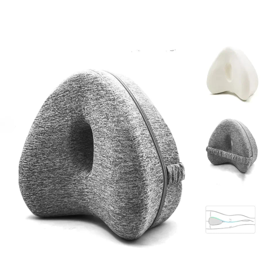 A love-shaped memory foam pillow with a gray cover, displayed in a neutral setting with variants in color and packaging.