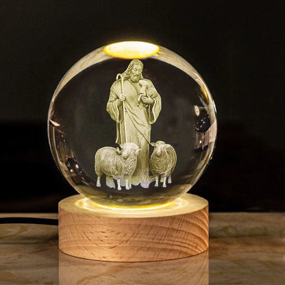 A luminous crystal globe with a cross design, glowing from within, placed on a wooden stand.