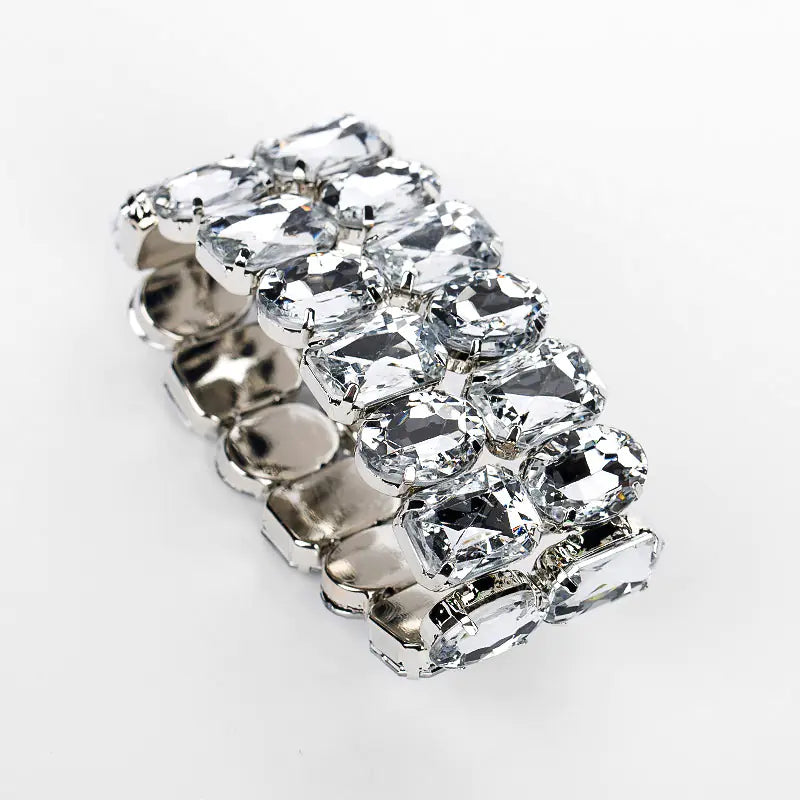 A silver fashion bracelet with a leaf shape and adorned with dazzling rhinestones.