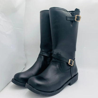 A pair of brown mid-tube flat-bottomed wedge boots with buckles and a pointed toe.