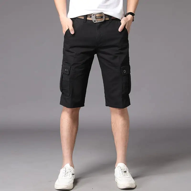 A pair of men's casual black shorts, showing a straight fit and mid-waist rise. The image depicts the shorts worn with a white t-shirt and white sneakers, highlighting the casual and outdoor-friendly style.