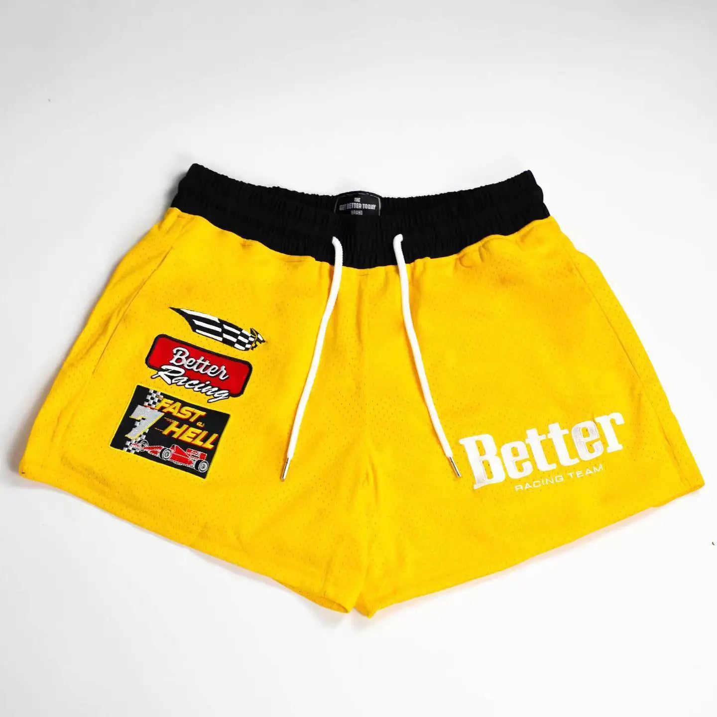 A pair of black men's basketball shorts with white drawstrings and white embroidery that reads 'Better' on the front, along with a small logo and text on the left leg.