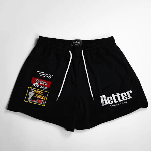 A pair of black men's basketball shorts with white drawstrings and white embroidery that reads 'Better' on the front, along with a small logo and text on the left leg.