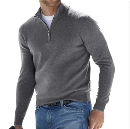 A man wearing a long-sleeve cashmere undershirt in purple with a collar, paired with blue jeans.