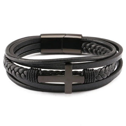 A men's retro braided leather and steel bracelet with a black color scheme, featuring a metallic clasp and a geometric pattern on the cross symbol, displayed on a wooden surface.