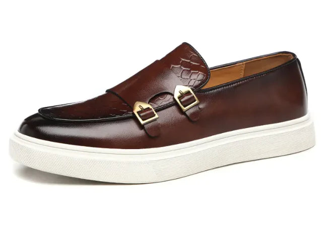 A black casual leather shoe for men featuring a slip-on design with a decorative buckle and a white sole.
