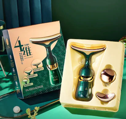 A multifunctional face massage instrument displayed in an open box, with a green and gold color scheme. The product includes a main handle, a beauty instrument, and replacement heads.