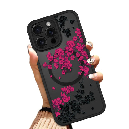 A hand holding a black iPhone 11 Pro Max case with a translucent floral flowers design on the back.