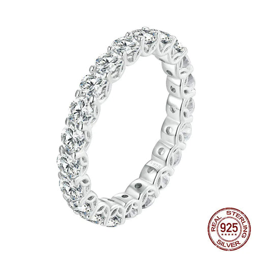 A sterling silver openwork pattern moissanite ring with a central stone, displayed against a white background.