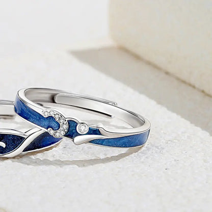 A sterling silver couple ring with a starry sky design, featuring blue enamel and a small diamond at the center.