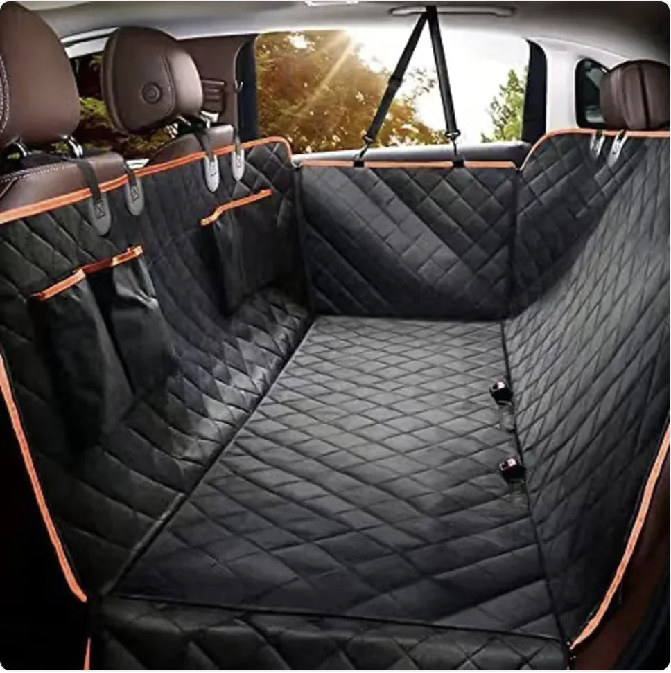 A black Oxford cloth car pet seat cover with orange edges installed in the back seat of a vehicle, featuring a double pocket design.