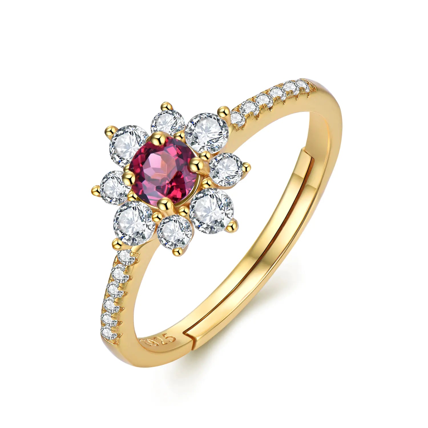 A gold-colored ring with a flower-like design featuring a central garnet-colored gem surrounded by white stones, with a diamond band.